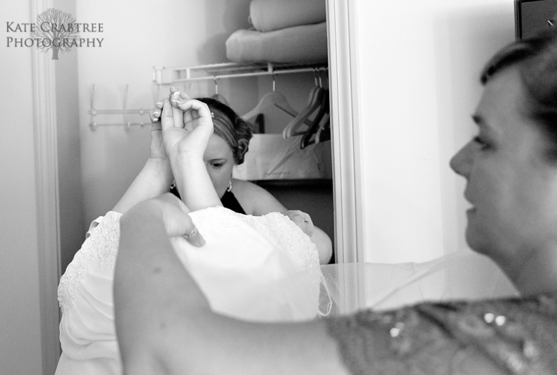 Maine wedding photographer Kate Crabtree captures the bride getting into her wedding dress at Sunday River