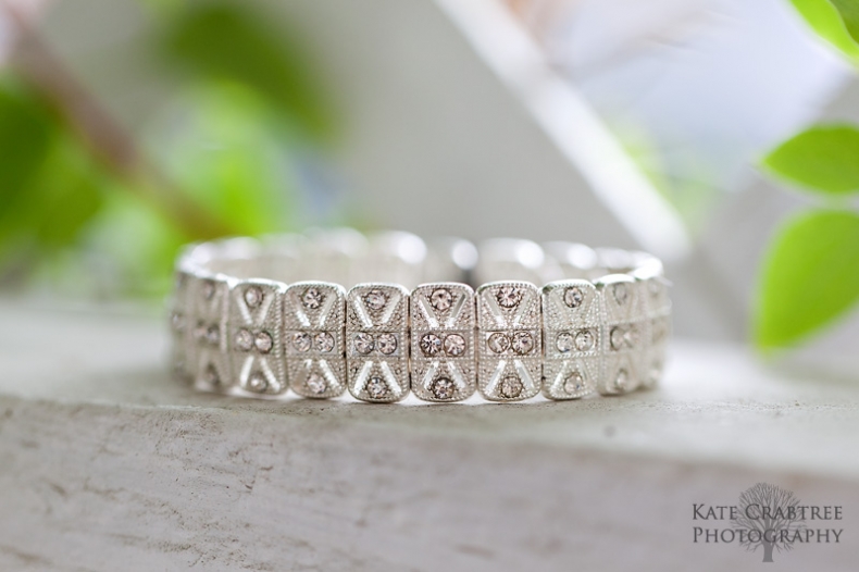 Central Maine wedding photographer Kate Crabtree takes a photo of a bracelet