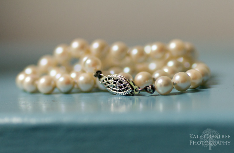 A detail shot of the bride's pearl necklace