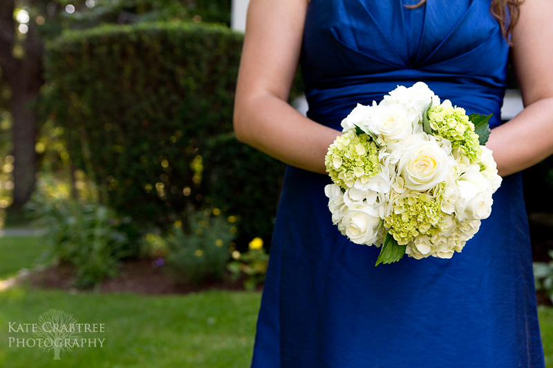 A bridesmaid shows off her wedding bouquet in Camden Maine