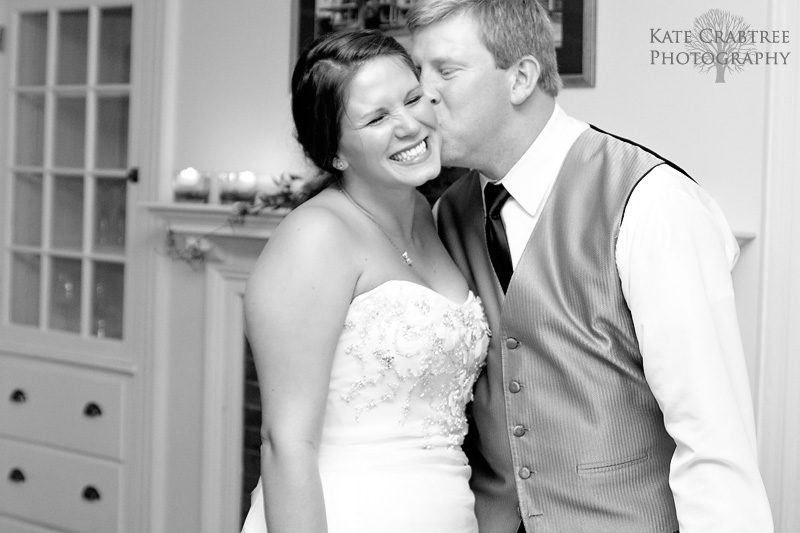 The groom kisses the bride on the cheek at the end of their Whitehall Inn wedding reception.