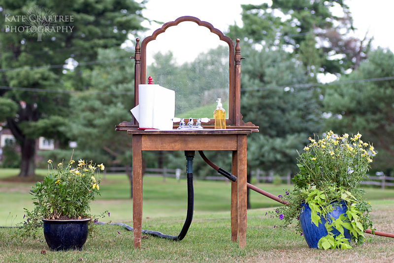 A unique sink setup for guests to use at this outdoor tented wedding at the Lakeview Golf Course in Central Maine