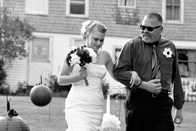 The bride is walked down the aisle by her proud father in Central Maine