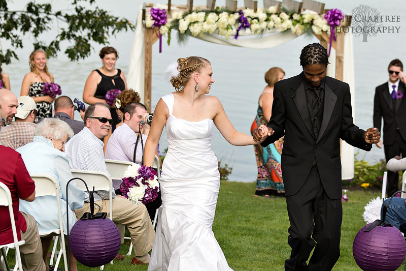 The bride and groom dance down the aisle in celebration of their Lakeview Golf Course wedding in Central Maine