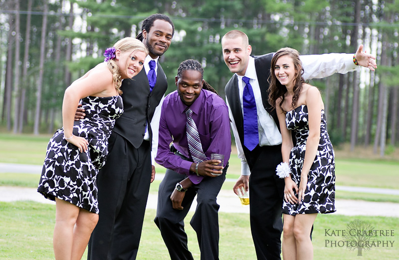 The bridal party pose in this naturally lit candid photo at the Lakeview Golf Course in Central Maine