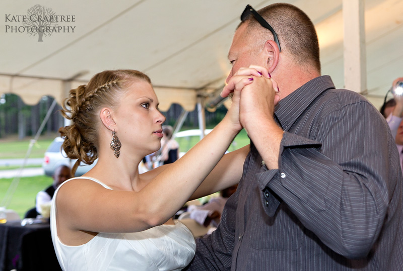 The father of the bride shares a touching moment with his daughter at the Lakeview Golf Course in Central Maine