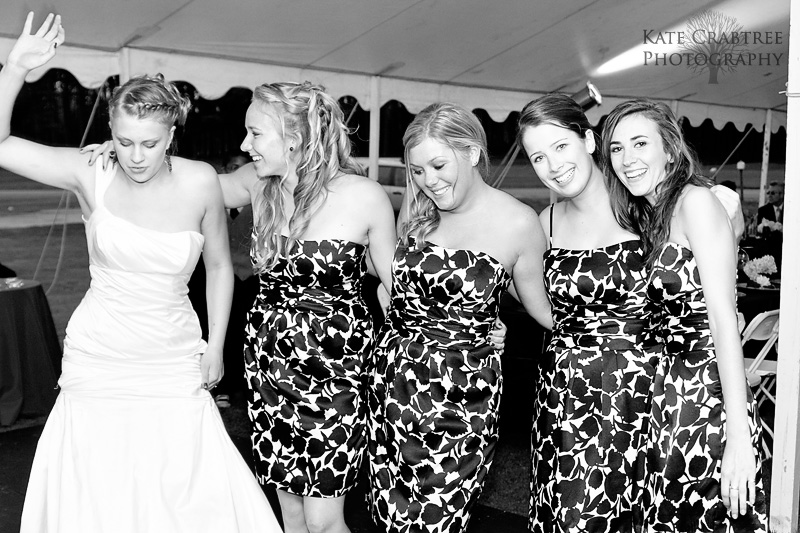 The bridal party shares a candid moment during the Lakeview Golf Course wedding reception.