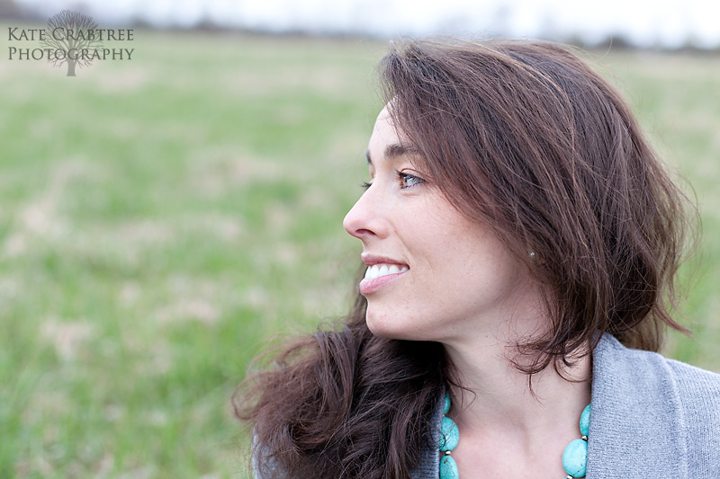 Elizabeth Allen poses in a field for her headshots in central Maine
