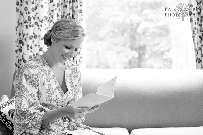 at a midcoast Maine wedding the bride reads a heartfelt card from her groom.