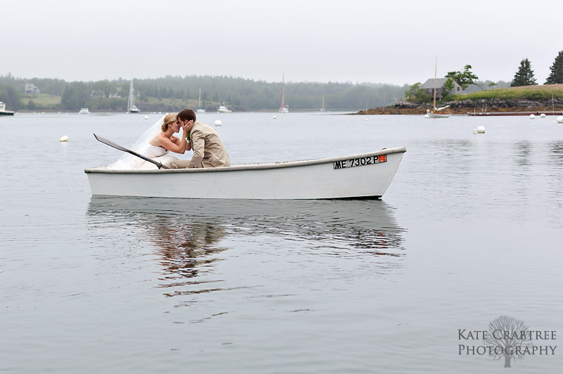 Maine coastal wedding photographer Kate Crabtree takes a photo of a lovely bride and groom in a rowboat