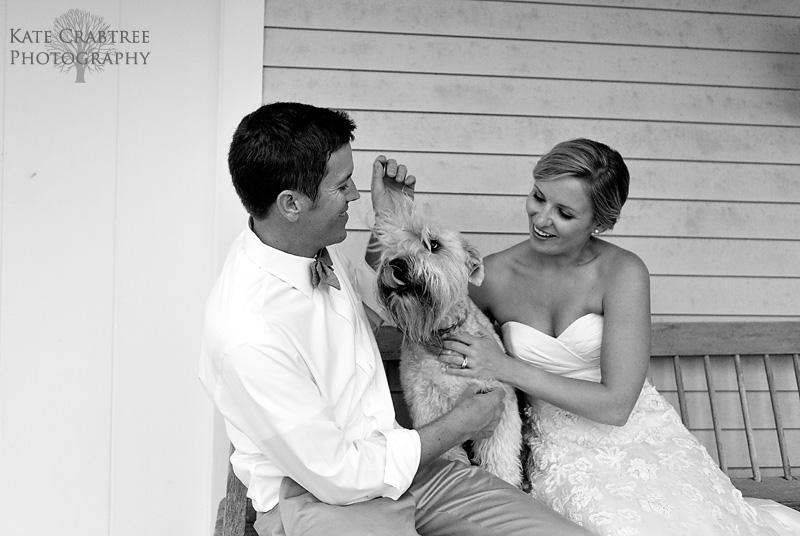 Susannah Stone and Gardner Brown hug their dog, Beau, at their wedding reception in coastal Maine