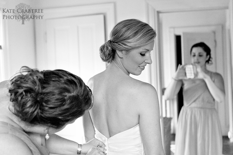 During this midcoast Maine wedding the bridesmaids help their friend the bride get ready for her big day