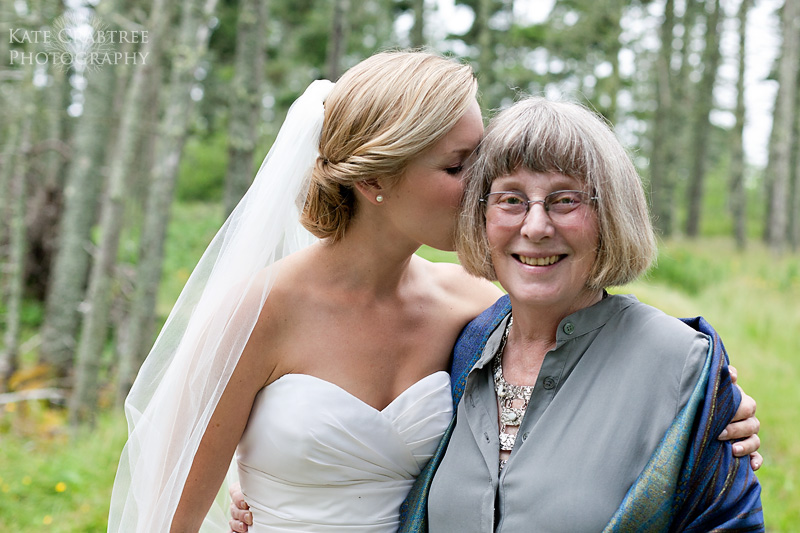 In this Maine wedding photo by Kate Crabtree the bride and mother of the bride share a moment