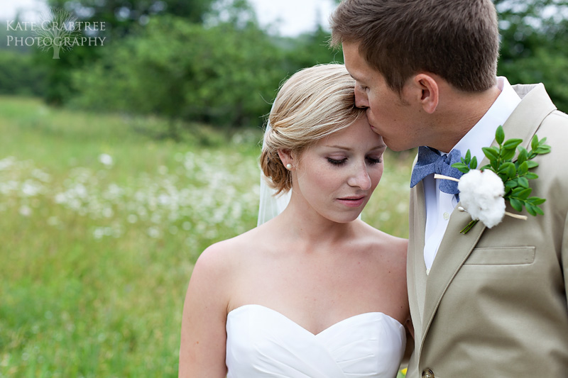 This maine groom kisses the bride, Susannah Stone, on the forehead during their formal portraits