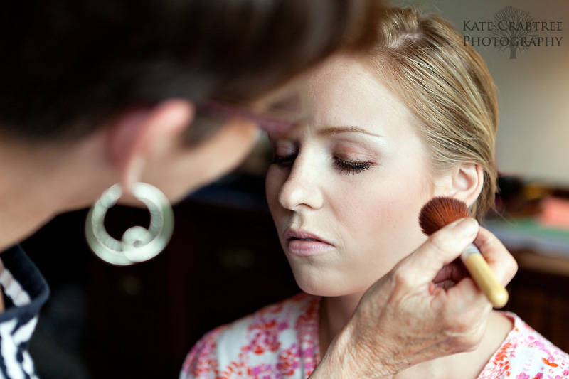 The makeup artist, Cyndi Clayton, carefully applies makeup to Susannah Stone so she'll be picture perfect for her coastal Maine wedding