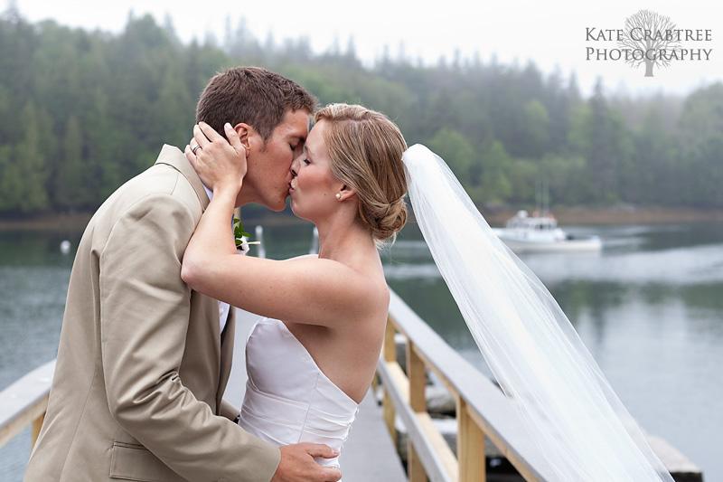 The bride and groom embrace at their oceanside wedding in Maine