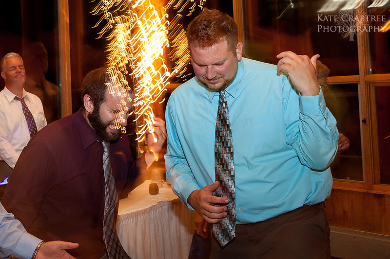 Wedding guests play the air guitar at a wedding reception in this photo at sunday river in maine