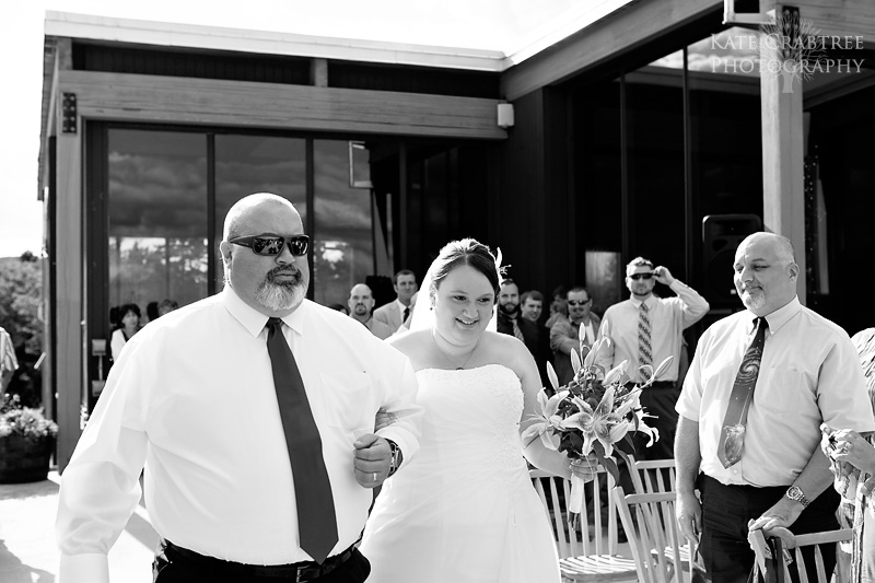 A photo of the father of the bride walking the bride down the aisle at Sunday River in Maine
