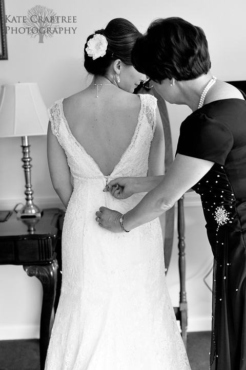 Laura's mom helps Laura get into her wedding dress at the Lucerne Inn in Maine