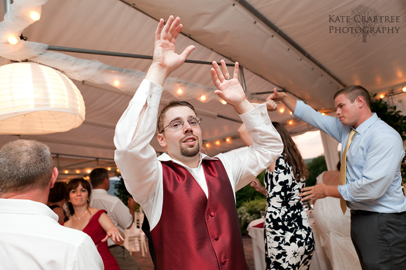 The groom throws his hands in the air while dancing at The Lucerne Inn wedding