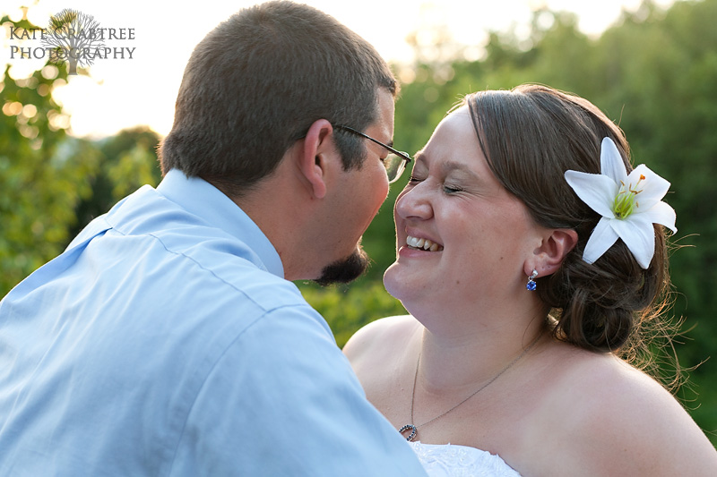 The bride and groom laugh during a portrait session at sunset in Maine on their wedding day