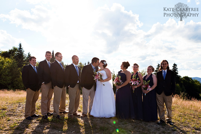 The entire wedding party surrounds the bride and groom on Sunday River in western Maine