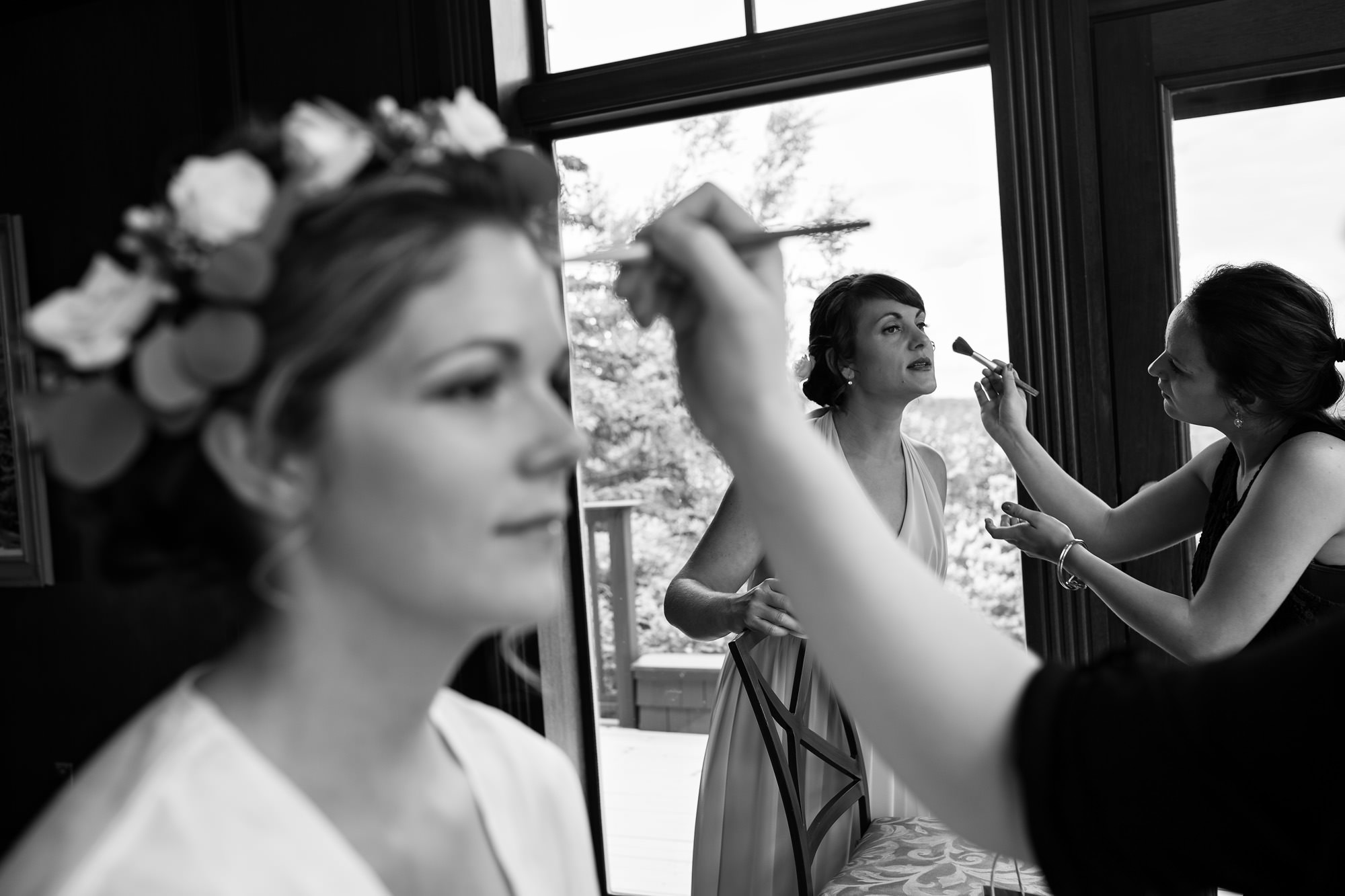 A bride and her bridesmaid get ready for a Point Lookout wedding in Northport Maine