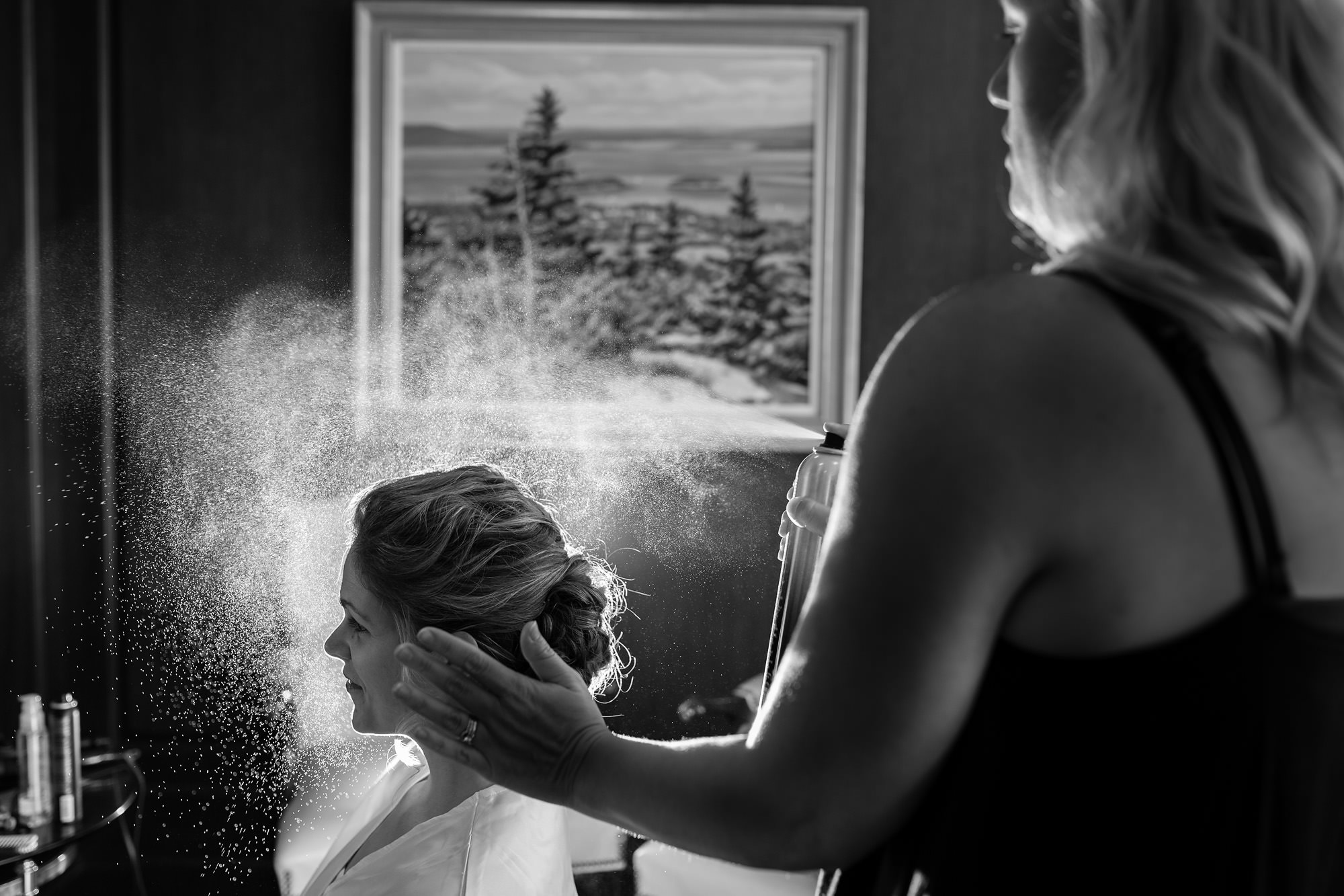 Bride having her hair done at a wedding in Maine