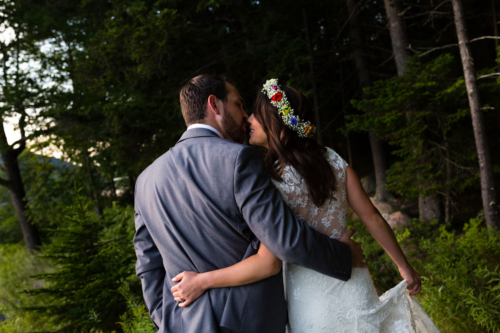 A bride and groom take portraits at Jordan Pond after eloping in Acadia National Park