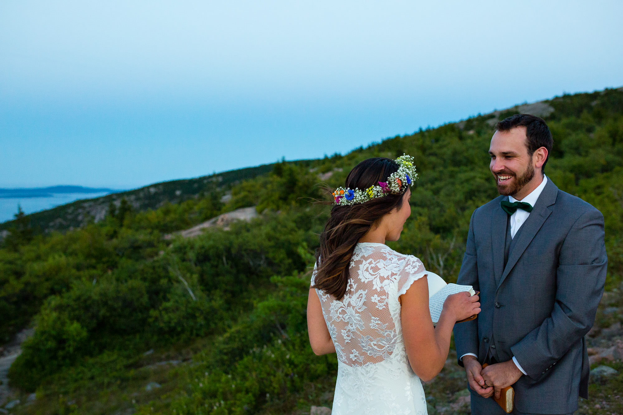 A bride and groom read vows during an emotional elopement on Cadillac Mountain