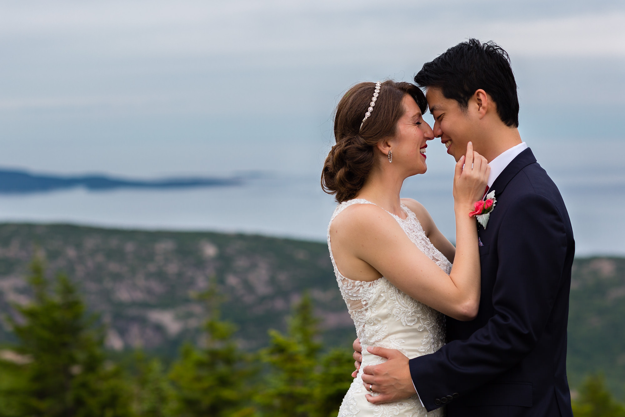 A bride puts on sneakers for portraits on Cadillac Mountain in Acadia