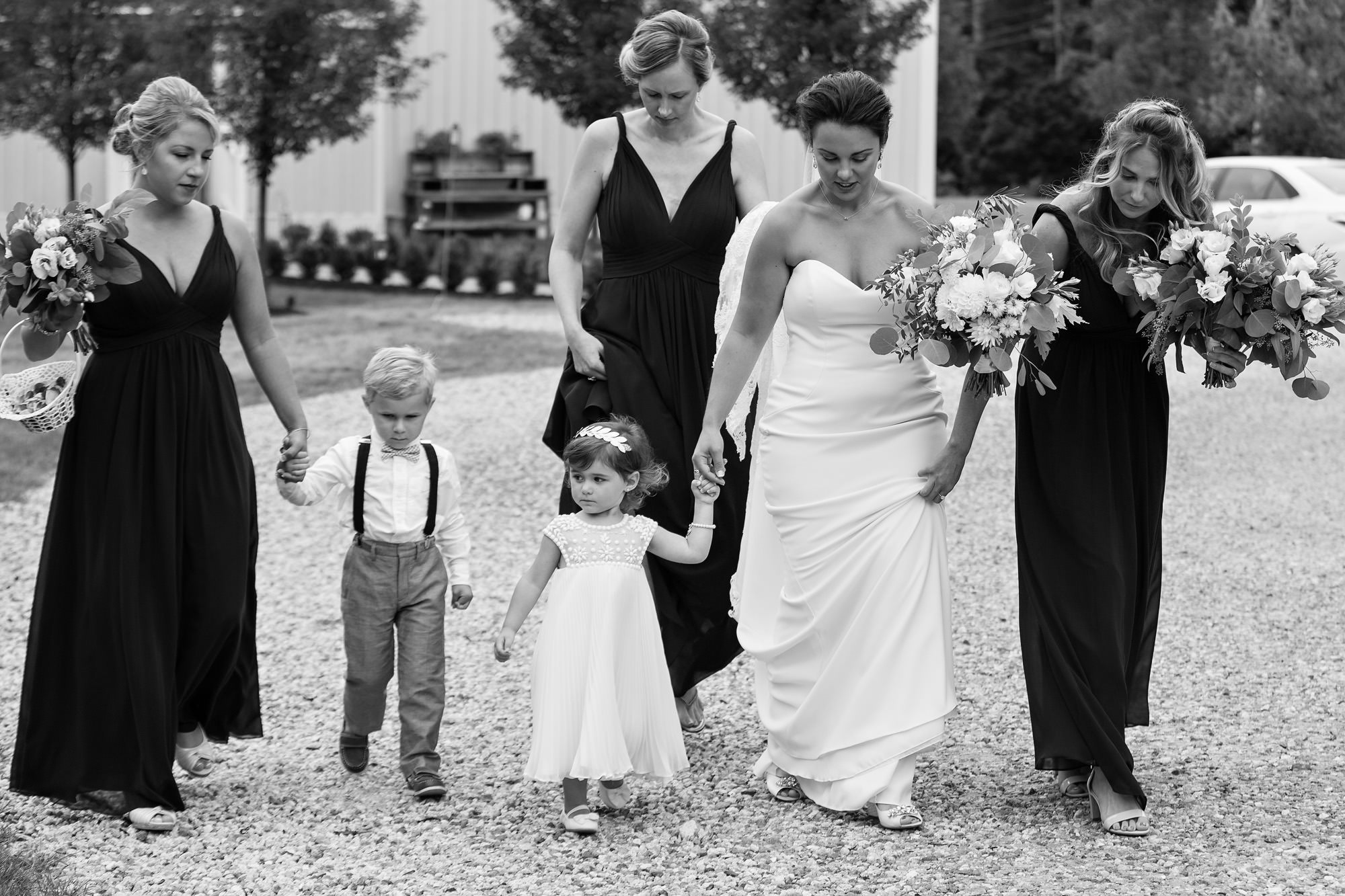 The bride walks with her bridesmaids to the wedding ceremony