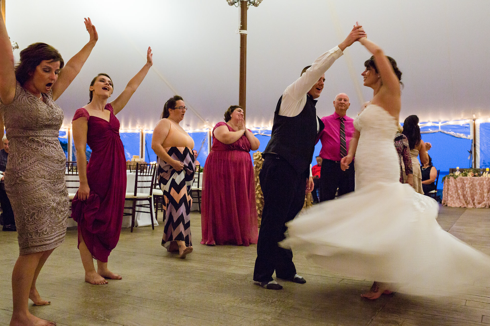 The bride, groom, and their friends dance during their wedding reception at French's Point in Maine