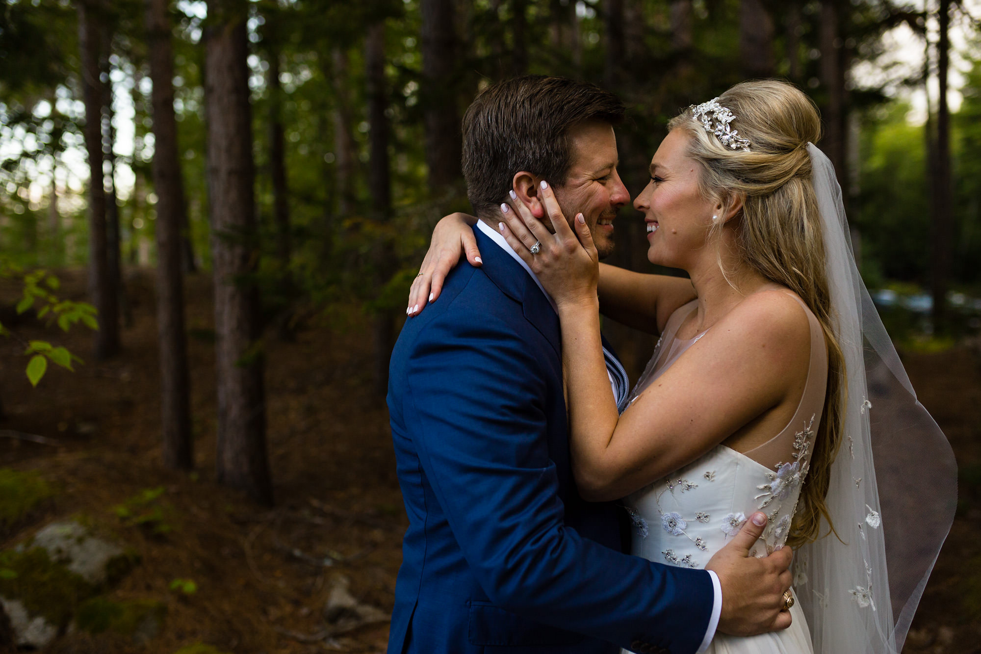 Portrait of a bride and groom in the forest of Hidden Pond.