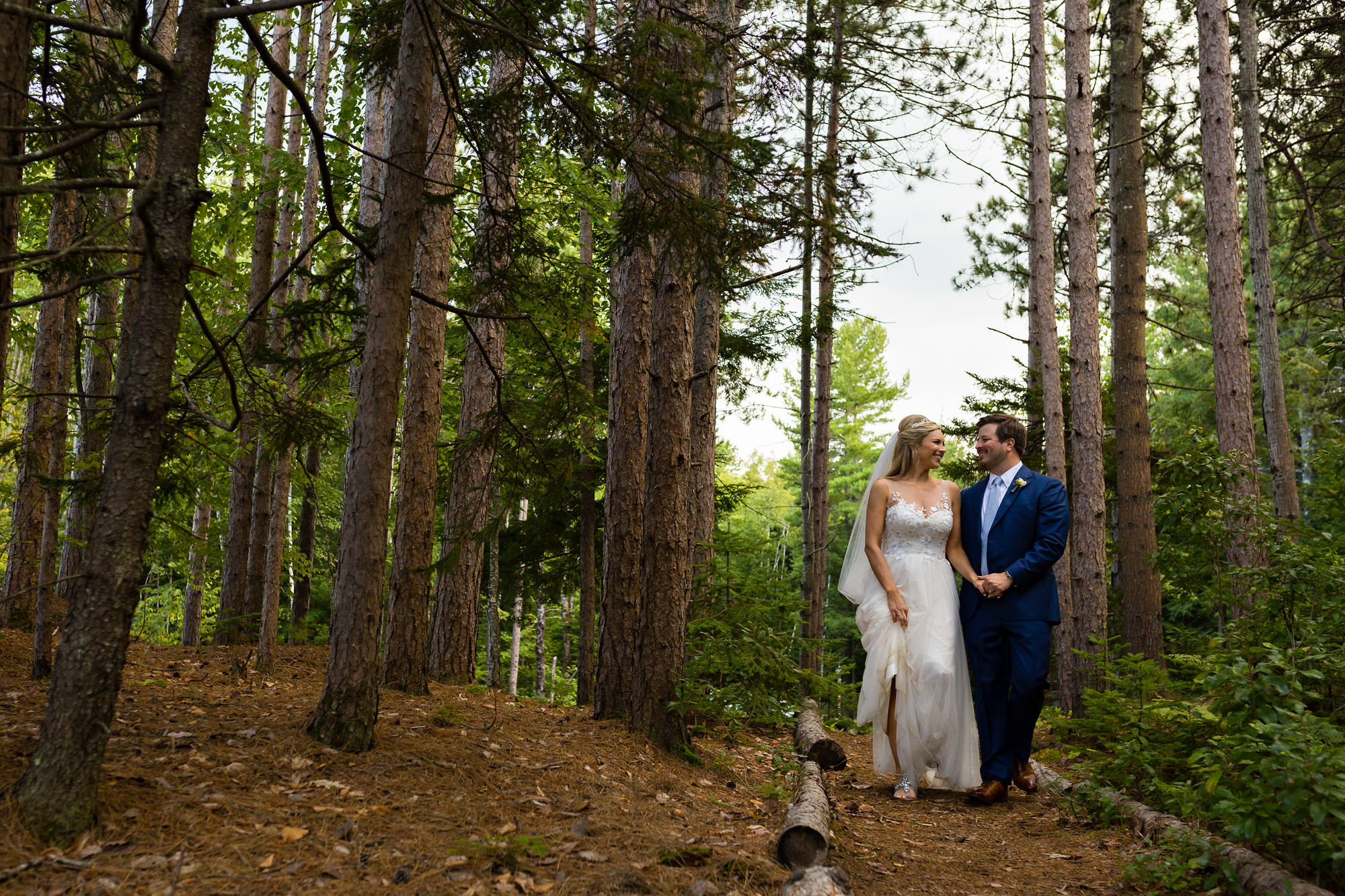 Portrait of a bride and groom in the forest of Hidden Pond.