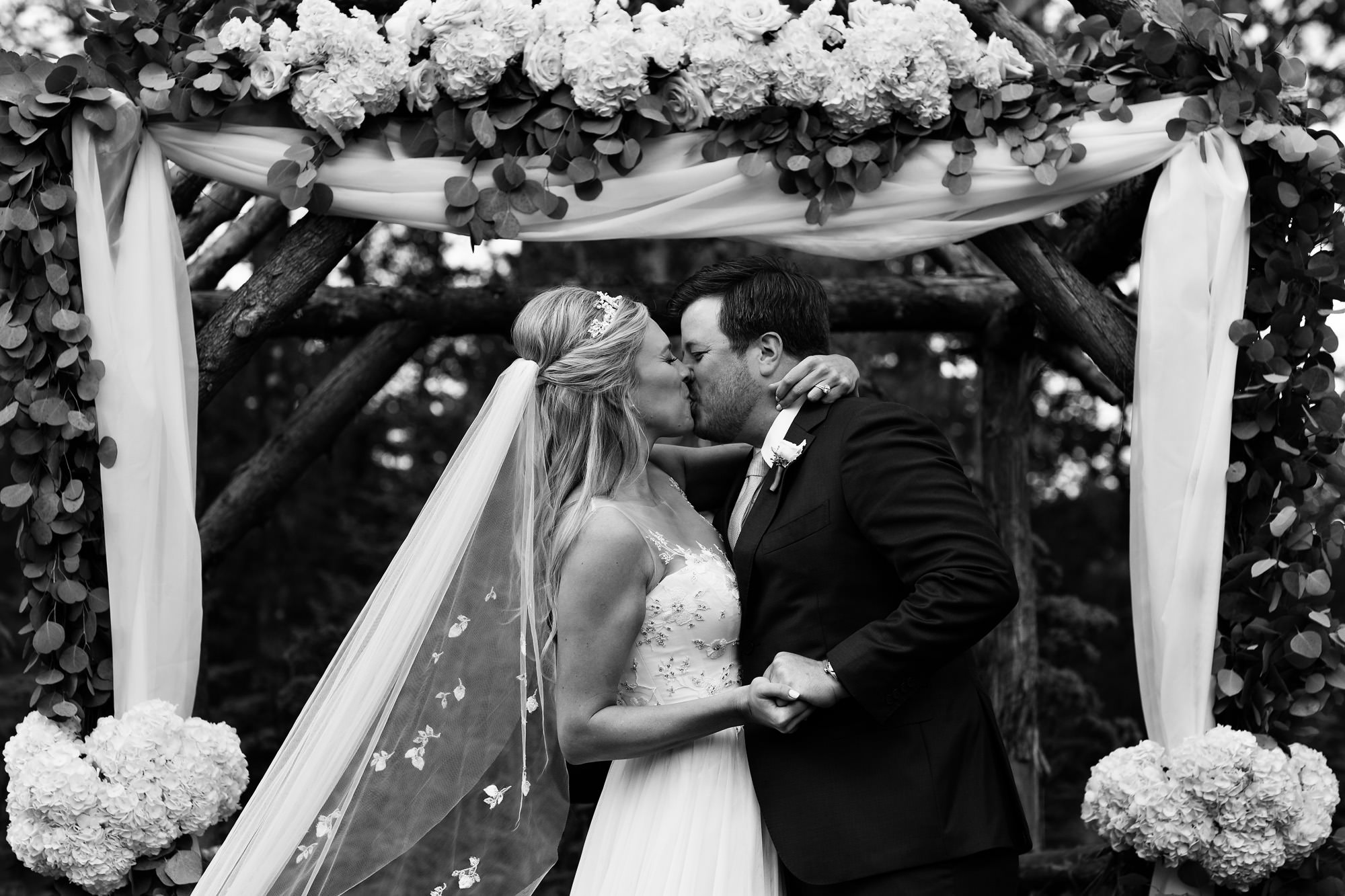 A striking first kiss at a Hidden Pond Kennebunkport wedding.