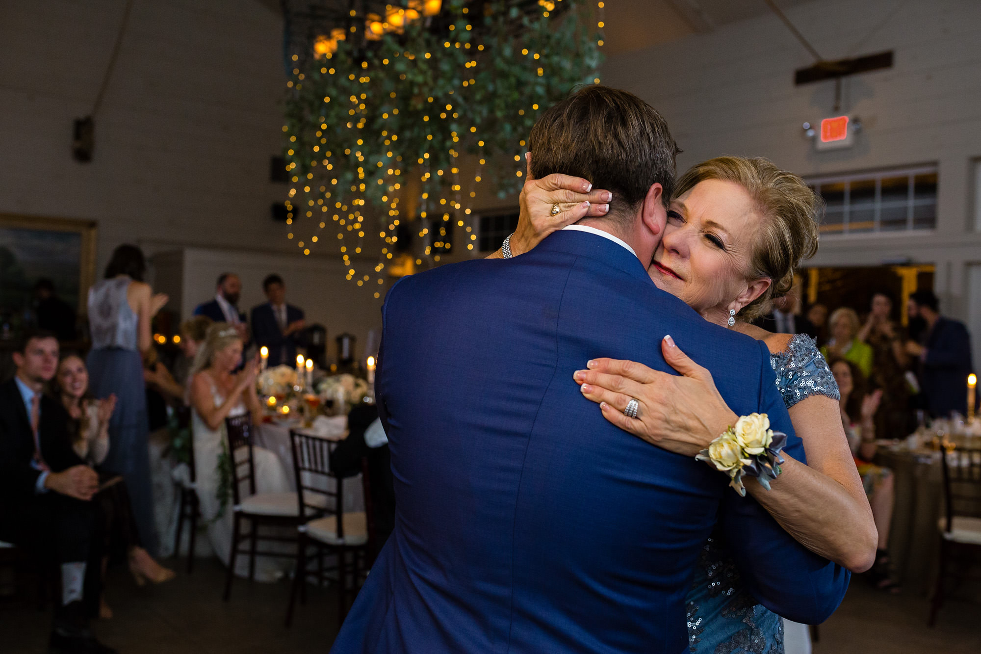 A happy dance shared with the groom and his mother at a Hidden Pond wedding.
