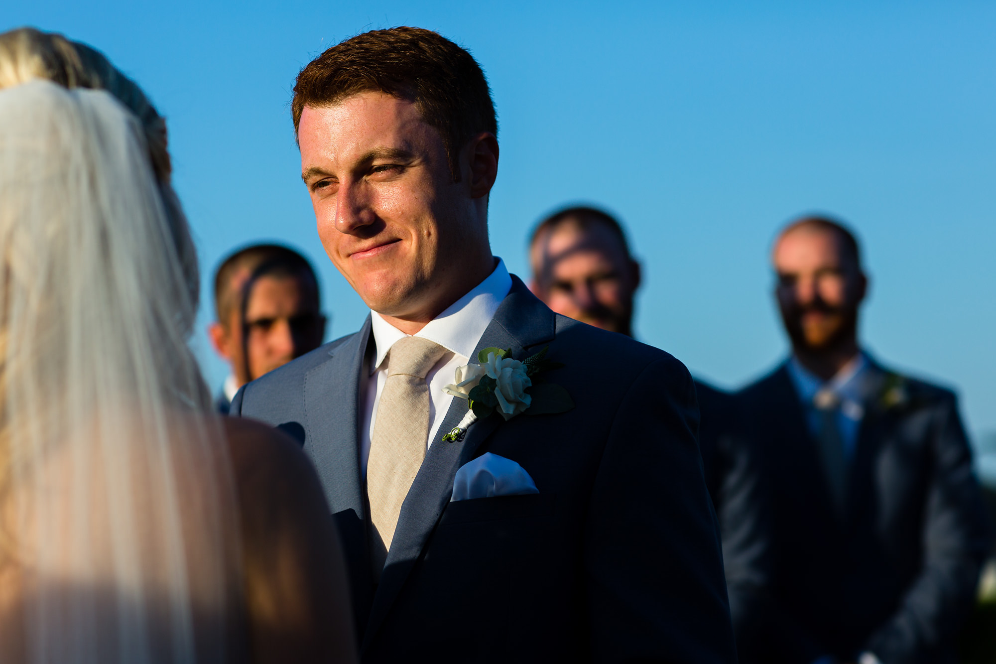 A groom stares into his bride's eyes at their Bar Harbor ewdding.