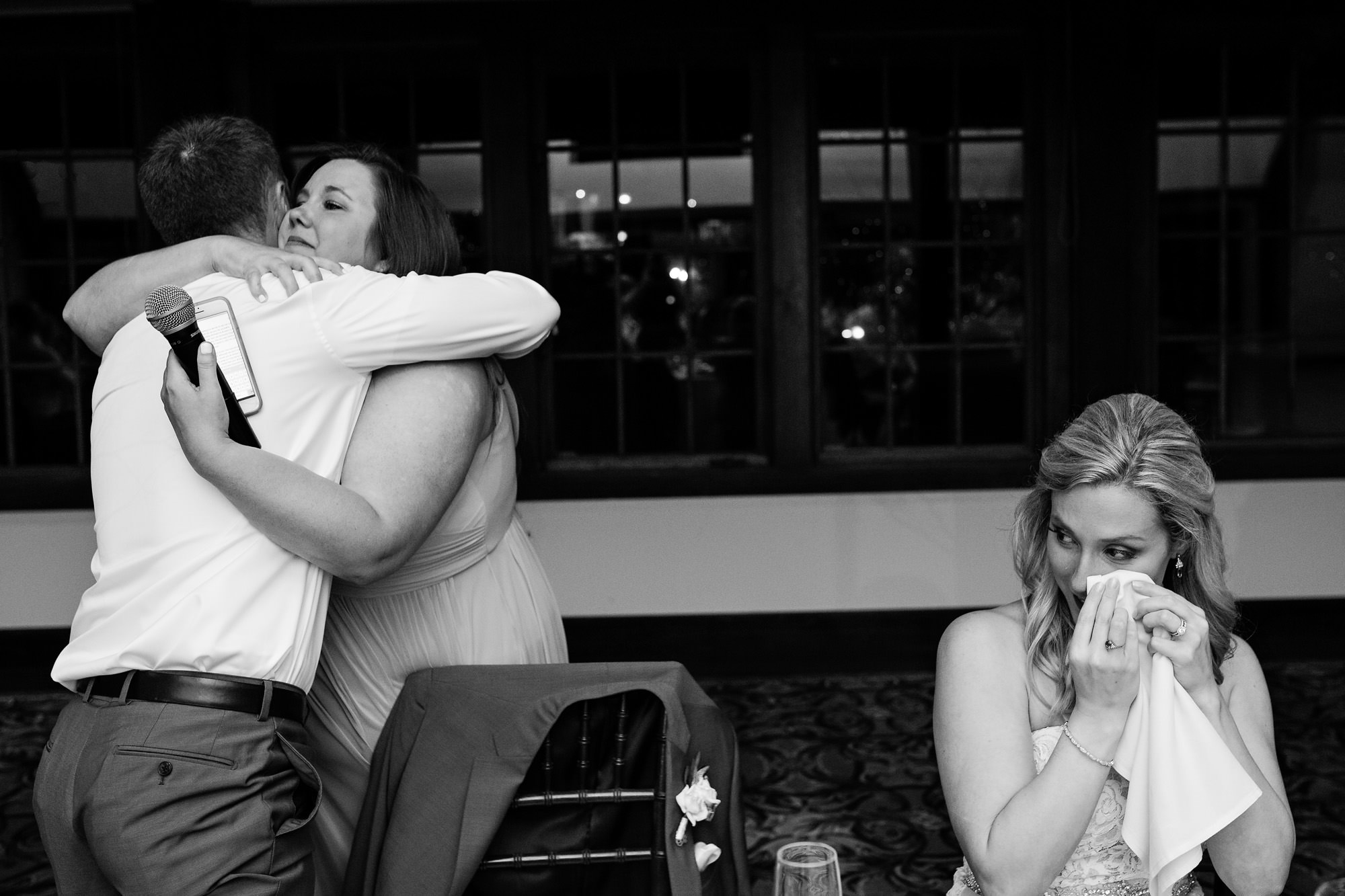 The bride had an emotional moment while her maid of honor hugged her husband