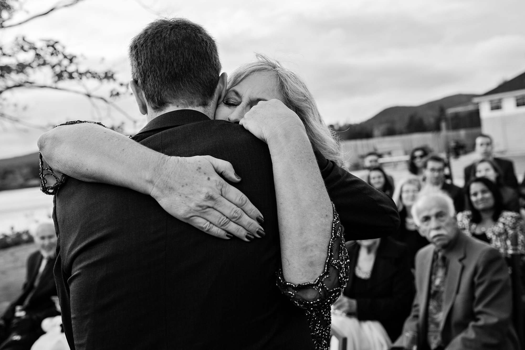 The mother of the groom hugs her son at his Southwest Harbor wedding ceremony