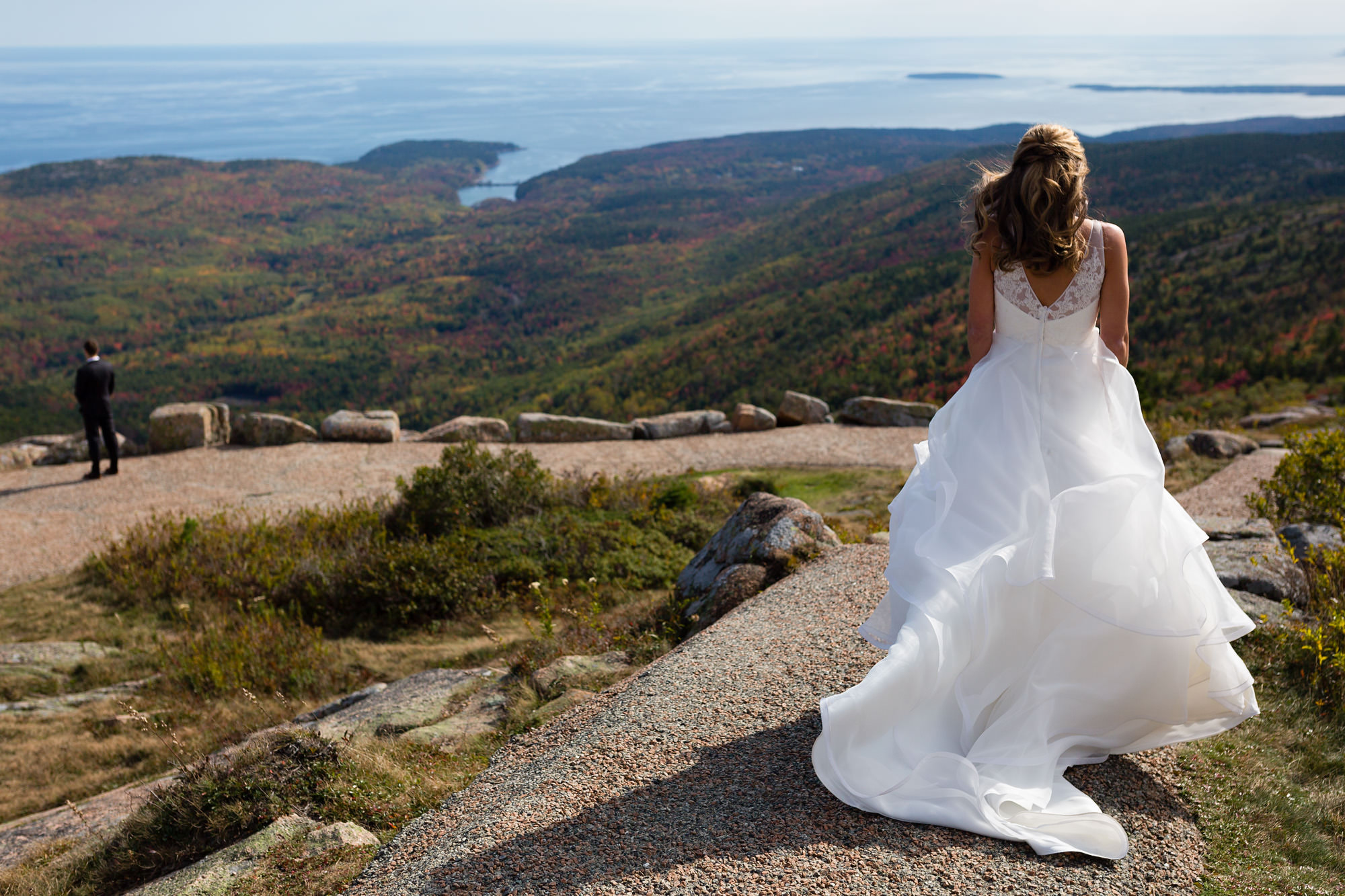 The bride and groom share a first look on top of Cadillac Mountain in Acadia National Park