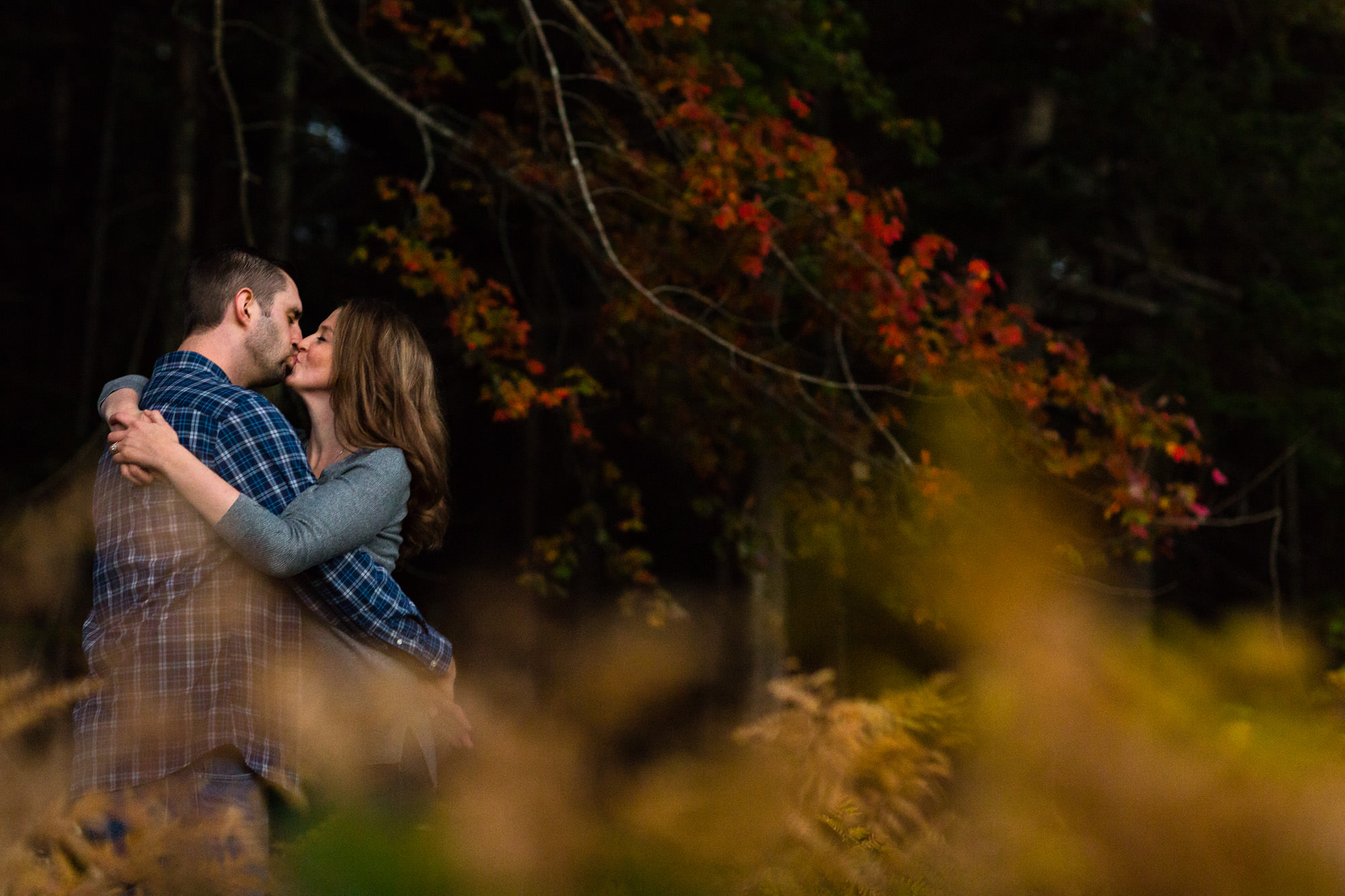 Jaimie and Cory kiss at Jordan Pond for their engagement photos on MDI