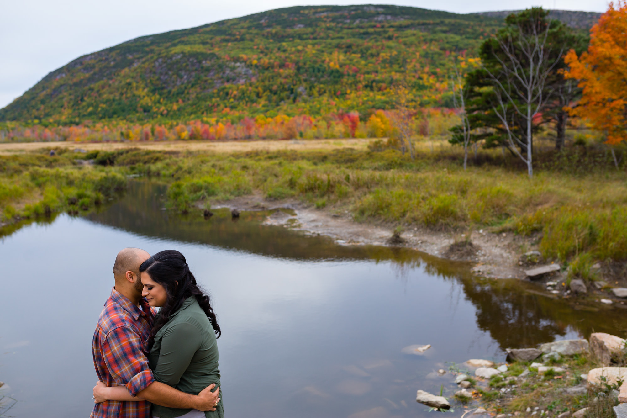 An engagement portrait of Bethany and Hebert in Acadia National park