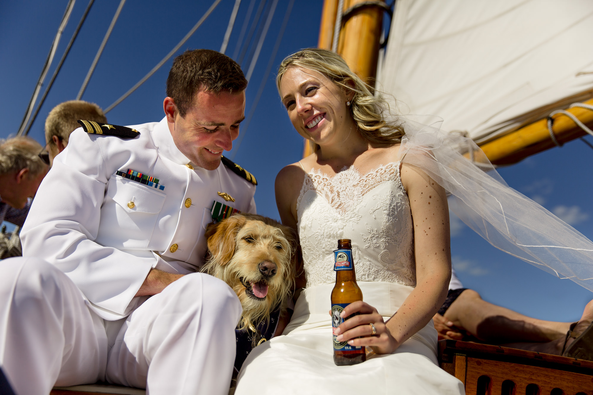 A bride and groom sail on the Schooner Olad after their wedding in Camden Harbor, Maine