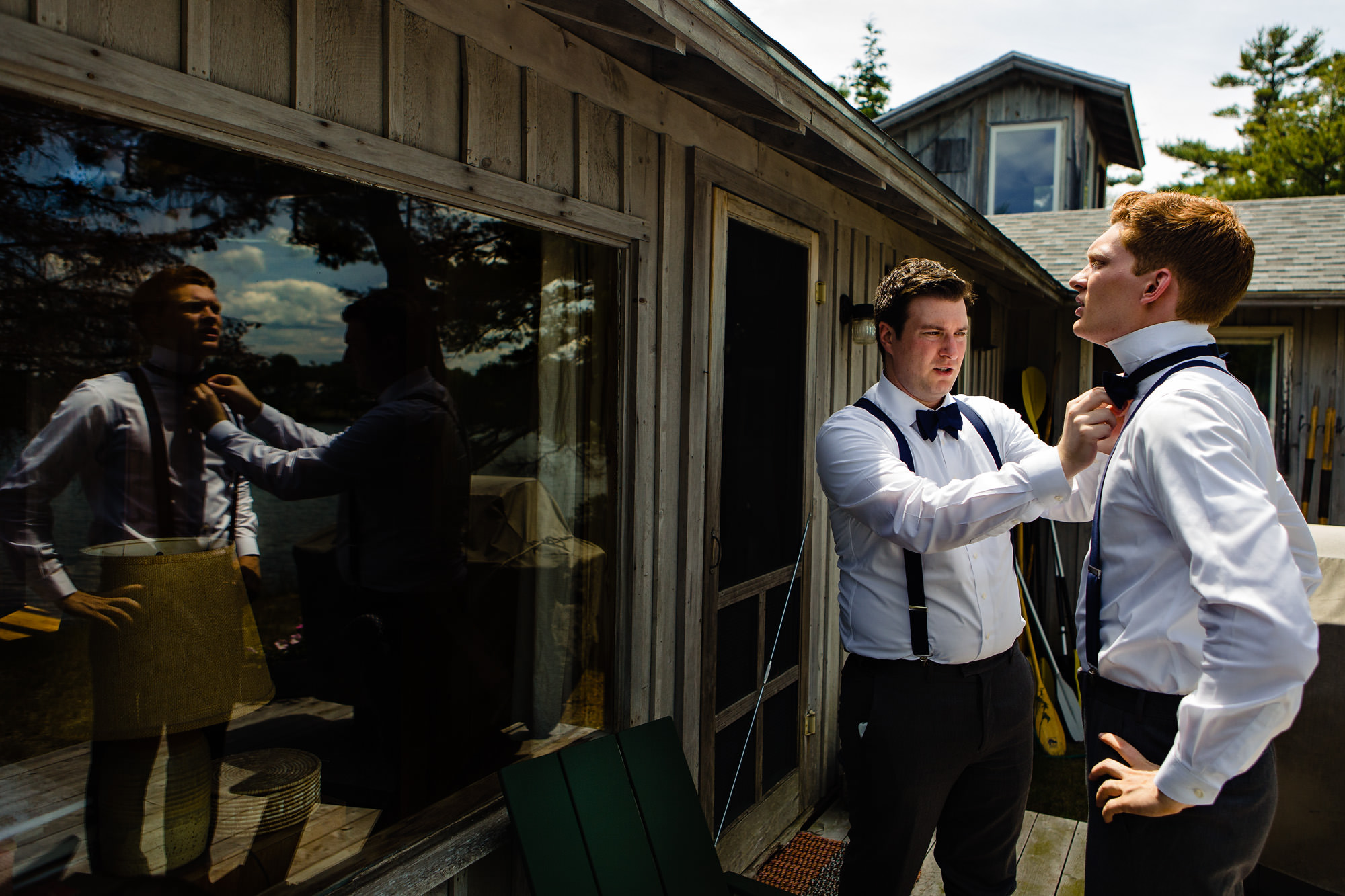 A groom and his groomsmen get ready at a cabin for his coastal Maine wedding