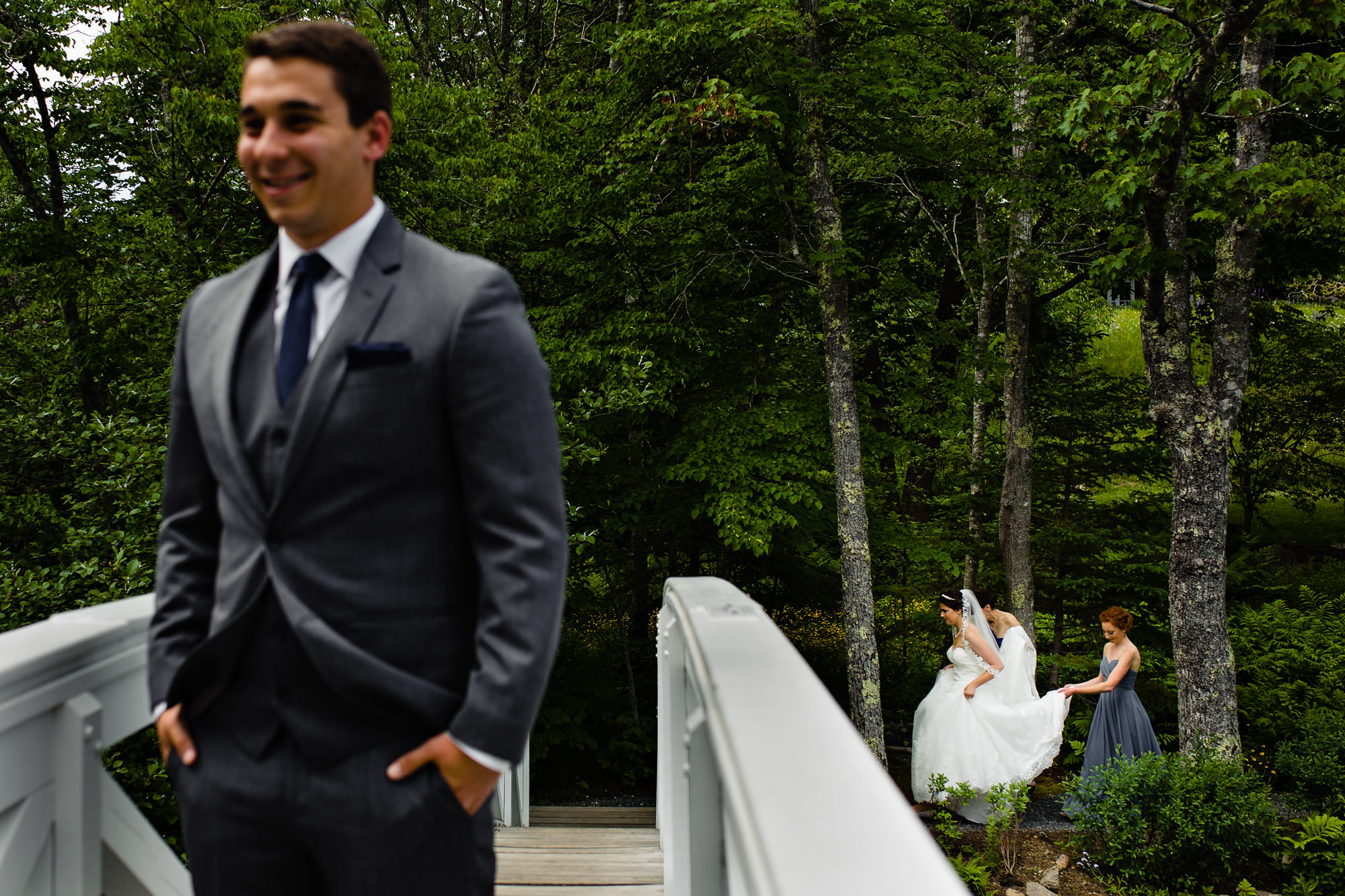 A bride heads to her first look with her groom at her coastal Maine wedding