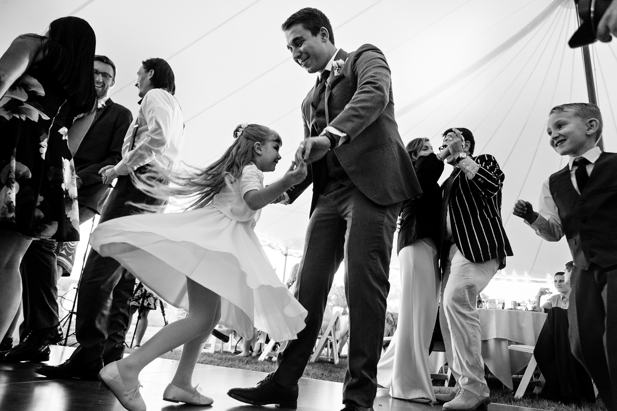 The groom dances with the flower girl.