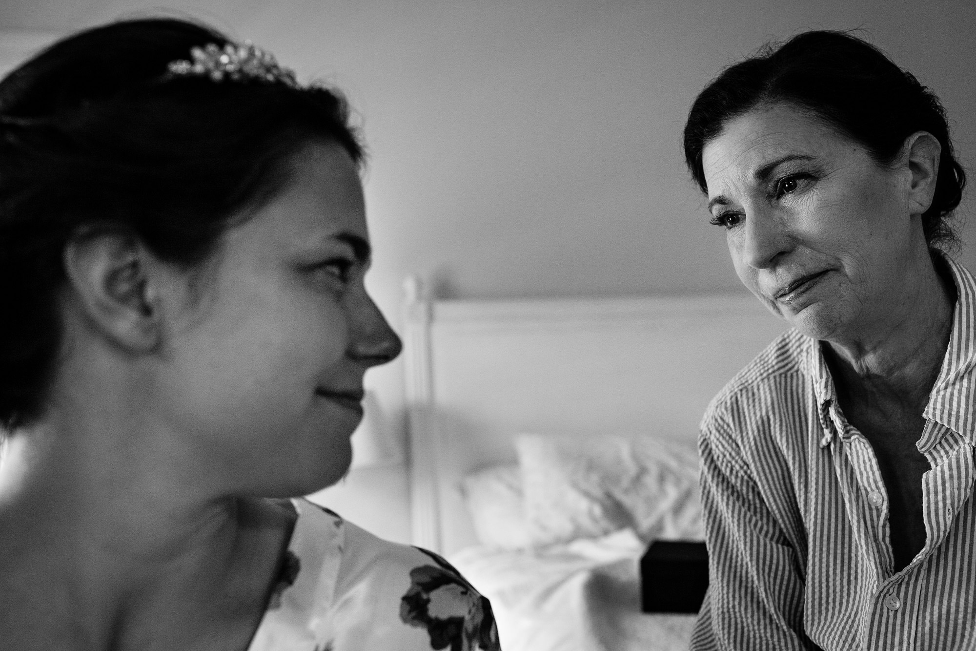 A bride shares an emotional moment with her mother at her coastal Maine wedding