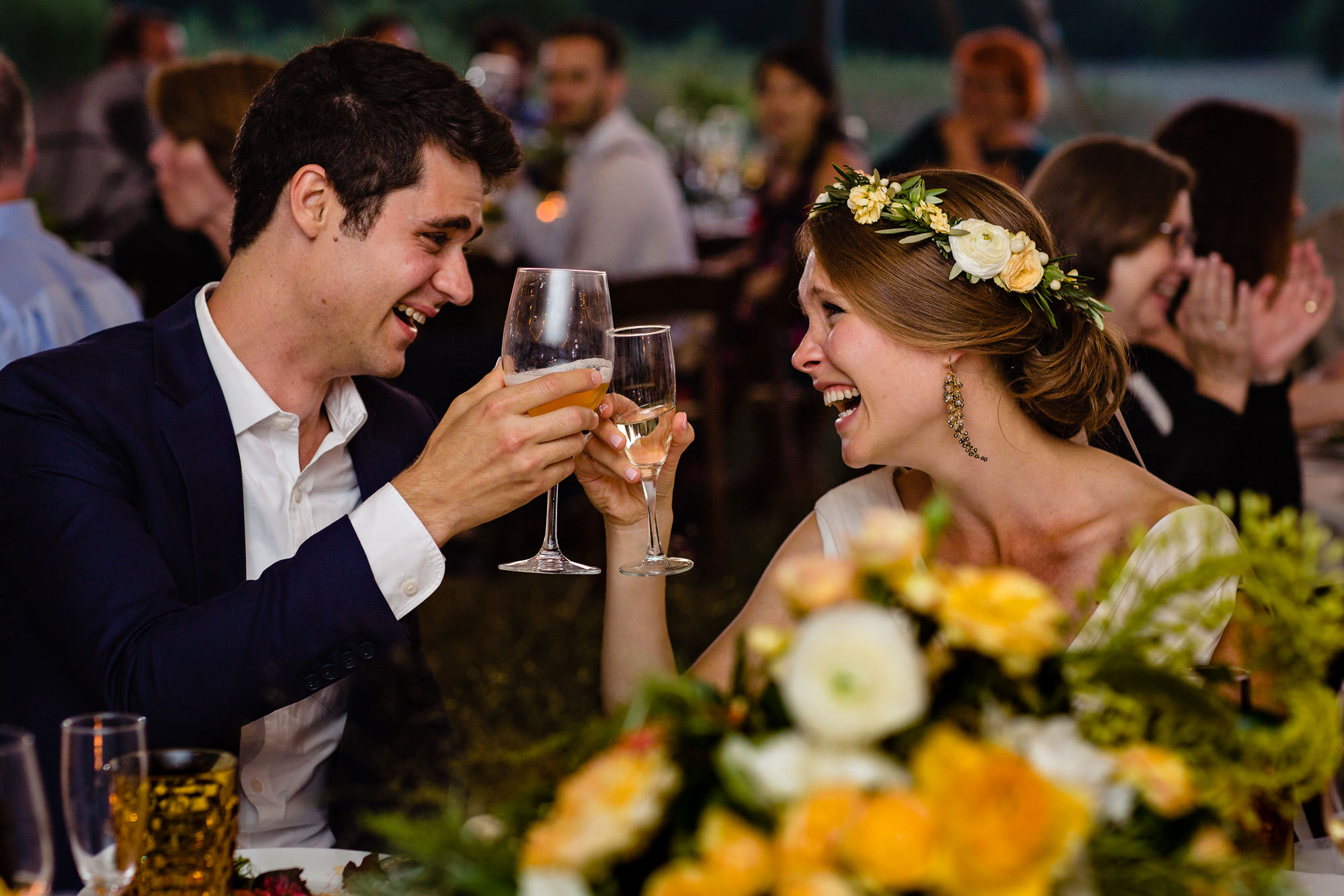 A bride and groom cheer and laugh at their Wells Reserve at Laudholm Farm wedding in Maine