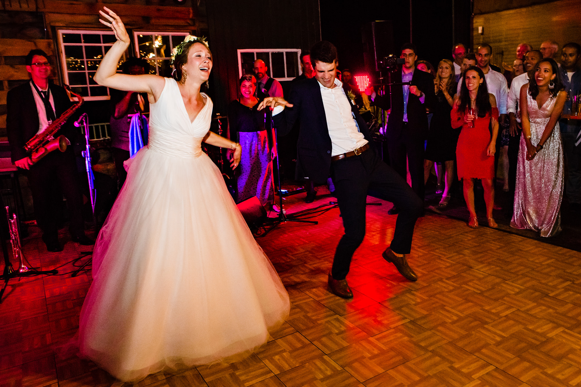 A wonderfully candid and fun dance floor at a wedding at Wells Reserve at Laudholm Farm in Maine
